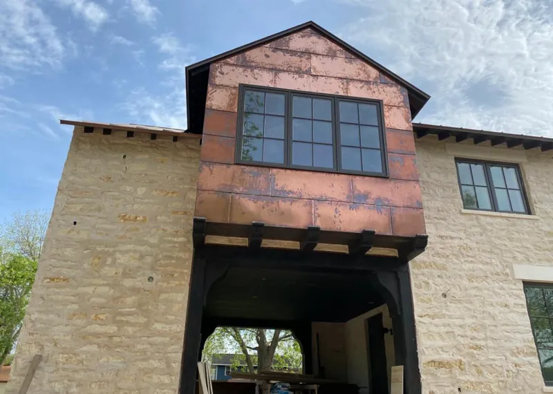 Copper metal panel facade on a stone building for Metal Roof Coating in Deming