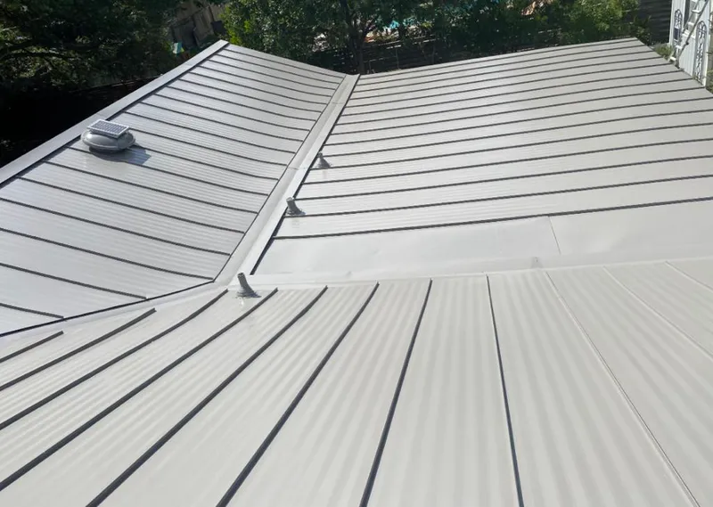 Solar attic fan installed on a metal roof for Roof Ventilation in Deming